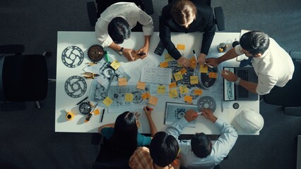 Time lapse of smart engineer team in casual cloth talking about turbine engine structure at table...