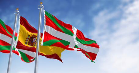 Basque Country and Spanish flags waving in the wind