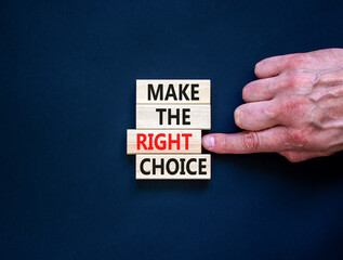 Make the right choice symbol. Concept words phrase Make the right choice on beautiful wooden blocks. Beautiful black background. Businessman's hand. Business Make the right choice concept. Copy space.