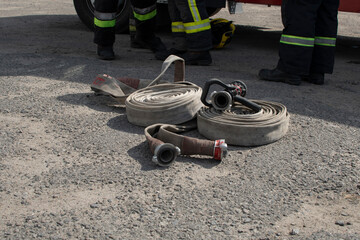Fire hoses and feet of a firefighters	