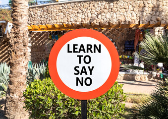 Learn to say no symbol. Concept words phrase Learn to say no on beautiful road sign. Beautiful palm...