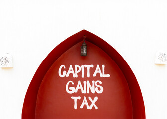 Capital gains tax symbol. Concept words Capital gains tax on beautiful white and red wall. Beautiful white and red wall background. Business and capital gains tax concept. Copy space.