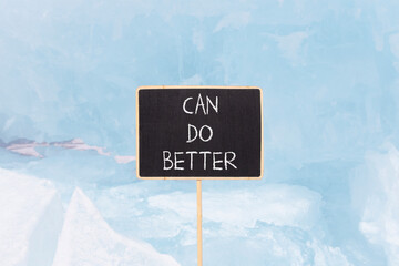 Can do better symbol. Concept words Can do better on beautiful blackboard. Beautiful blue ice and snow background. Business and can do better concept. Copy space.