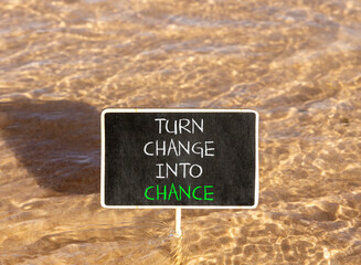 Turn change into chance symbol. Concept words phrase Turn change into chance on beautiful black blackboard. Beautiful Red sea water background. Business Turn change into chance concept. Copy space.