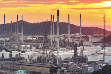 Oil refinery with water vapor in Hamburg, Germany, petrochemical industry during twilight.