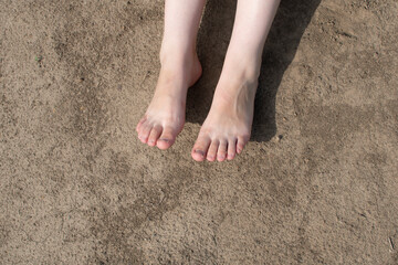 Naked female feet on dry ground	