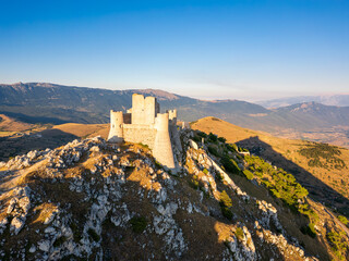 Italy, July 5, 2025: Ruins of Rocca Calascio Castle, an Italian tourist destination and landmark in the Gran Sasso National Park, L'Aquila, Abruzzo. Clear blue skies at sunset.