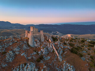 Italy, July 5, 2025: Ruins of Rocca Calascio Castle, an Italian tourist destination and landmark in the Gran Sasso National Park, L'Aquila, Abruzzo. Clear blue skies at sunset.