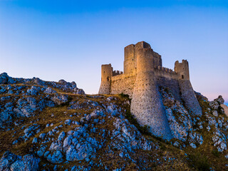 Italy, July 5, 2025: Ruins of Rocca Calascio Castle, an Italian tourist destination and landmark in the Gran Sasso National Park, L'Aquila, Abruzzo. Clear blue skies at sunset.