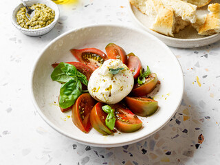 burrata with tomatoes, basil and pesto