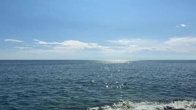 Blue sparkling ocean waves and sky.
