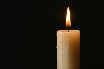 tall ivory candle placed on the far right of the frame