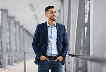 Handsome Young Middle Eastern Man Waiting Flight At Airport Terminal, Smiling Millennial Arab...