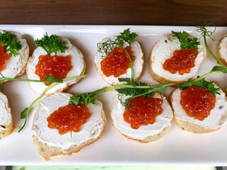 Assorted sandwiches and finger foods arranged on a buffet table. Ideal for catering, events, and social gatherings. Fresh, colorful, and appetizing presentation. Commercial license.
