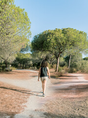 Woman choosing a path in a forest. Concept of decision making in life.