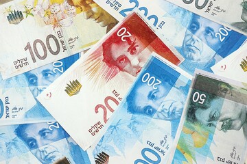 Israel New Shekels banknotes. The current Israel money bills lies on table in big amount