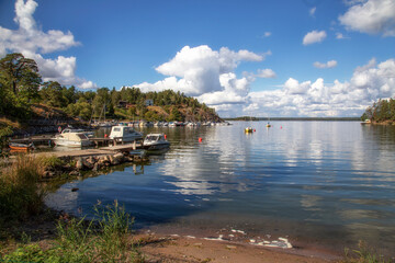 The shore of the sea bay and the boat station on a summer morning