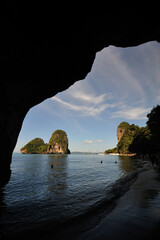 Silhoutte of few tourist enjoy swimming at Railay Beach in Krabi, Thailand.
