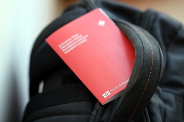 Swiss passport on travel bag. Pass on bag close up