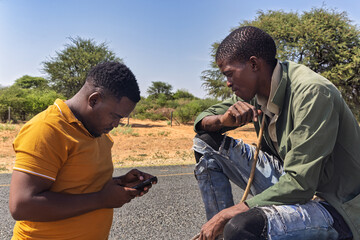 social worker with the phone checking entrepreneurs, donkey cart on the road, africa water shortage, people carry water between villages with plastic containers