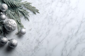 Elegant silver Christmas baubles and frosted pine branch on a pristine white marble background with snow, perfect for winter holidays.