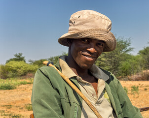 africa village, portrait of young african man , outdoors against the blue sky, bush in the backgrounds