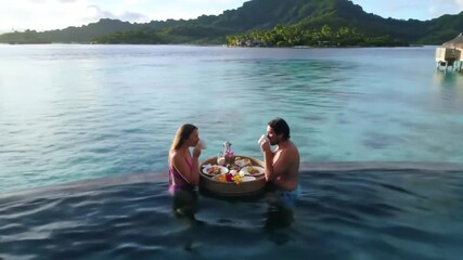 Couple in Bora Bora (French Polynesia)
Enjoying a floating breakfast in a private pool over the blue sea. - Powered by Adobe