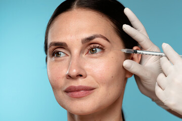 Woman Undergoing Cosmetic Injection Procedure with Doctor
