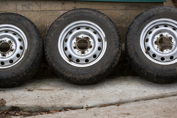 Wheels with old worn-out car tires.
