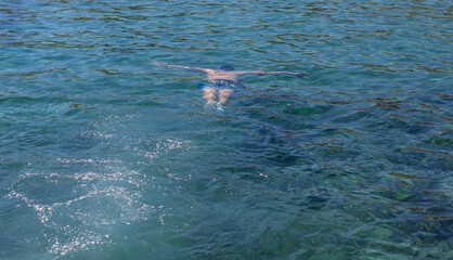 A man swims in the sea. Selective focus.
