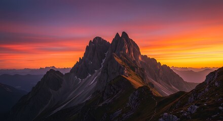 Sunlight hitting a dramatic mountain peak at golden hour