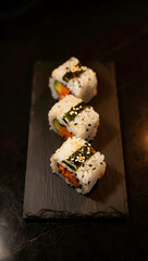 Elegant Sushi Rolls: Gourmet Food Photography, Dark Background, Close-Up View