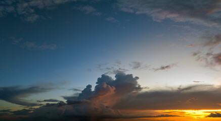Fototapeta premium Amazing sunset skyscape. Evening sky with bright colorful orange and yellow clouds