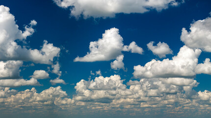 Blue sky with white summer rain clouds. Colorful summer landscape
