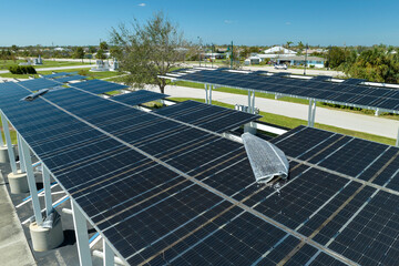 Destroyed by hurricane wind photovoltaic solar panels mounted on carport roof for producing green...