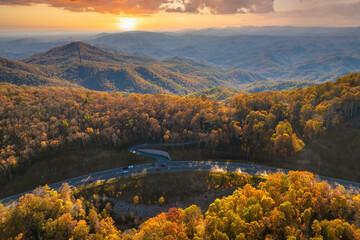 Elevated view of freeway road lanes between autumn mountain hills. Interstate transportation...