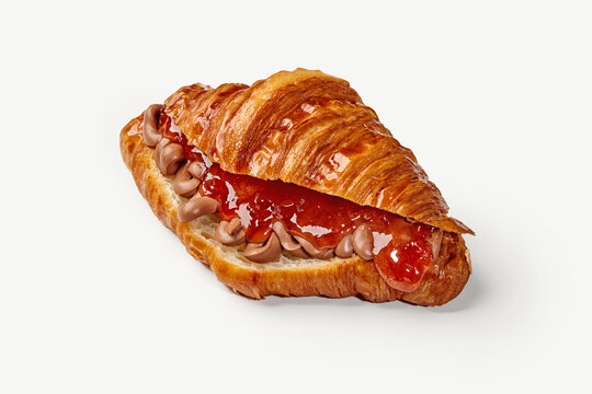 Delicious croissant filled with chocolate cream and strawberry jam on white background