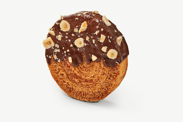 Delicious round pastry covered in chocolate and hazelnuts on white background