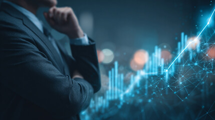 A businessman in a suit contemplates a glowing blue financial chart displaying a strong upward growth trend with network connections
