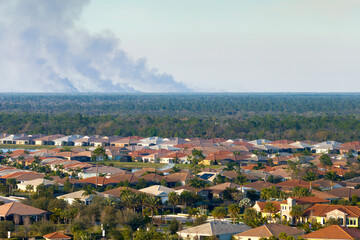 Suburban neighborhood in Florida suffering from bad air quality polluted with prescribed forest...