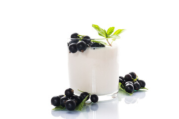 Blackcurrant with homemade yogurt in a glass on a white background