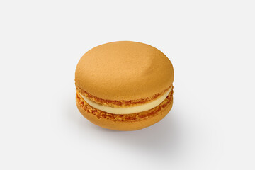 Single orange macaron with white filling on white background