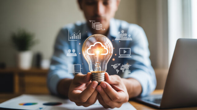 Innovative Cloud Computing Solutions A Man Holding a Light Bulb with Cloud Icon and Business Graphics for Digital Transformation