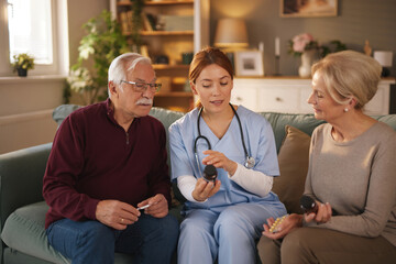 In a bright, cozy living room, a female home caregiver shows and explains medication instructions...