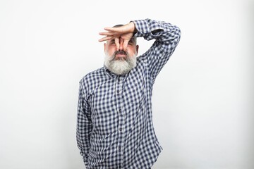 Mature man pinching nose due to bad smell on white background