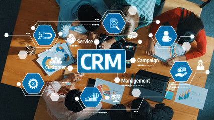 A dynamic overhead view of a team collaborating on customer relationship management strategies using visual icons to represent key concepts and workflows in a modern workspace. Amity