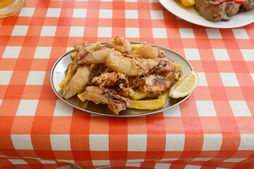 plate of fried squid with lemon slices