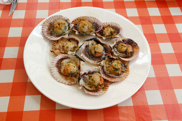dish of scallops with garlic, parsley and olive oil