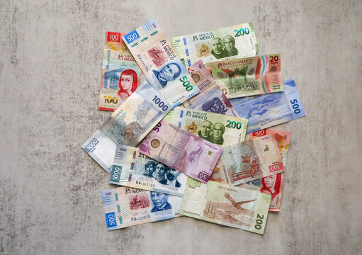 San Diego, CA USA on March 19, 2025. View of multiple denomination Mexican currency bills scattered around. Series G bank notes.