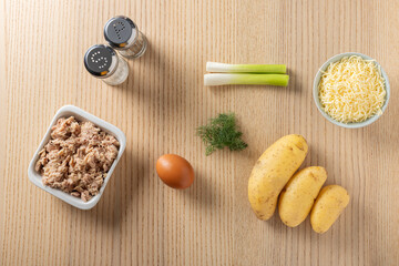 Fresh ingredients to prepare baked tuna and potato croquettes.